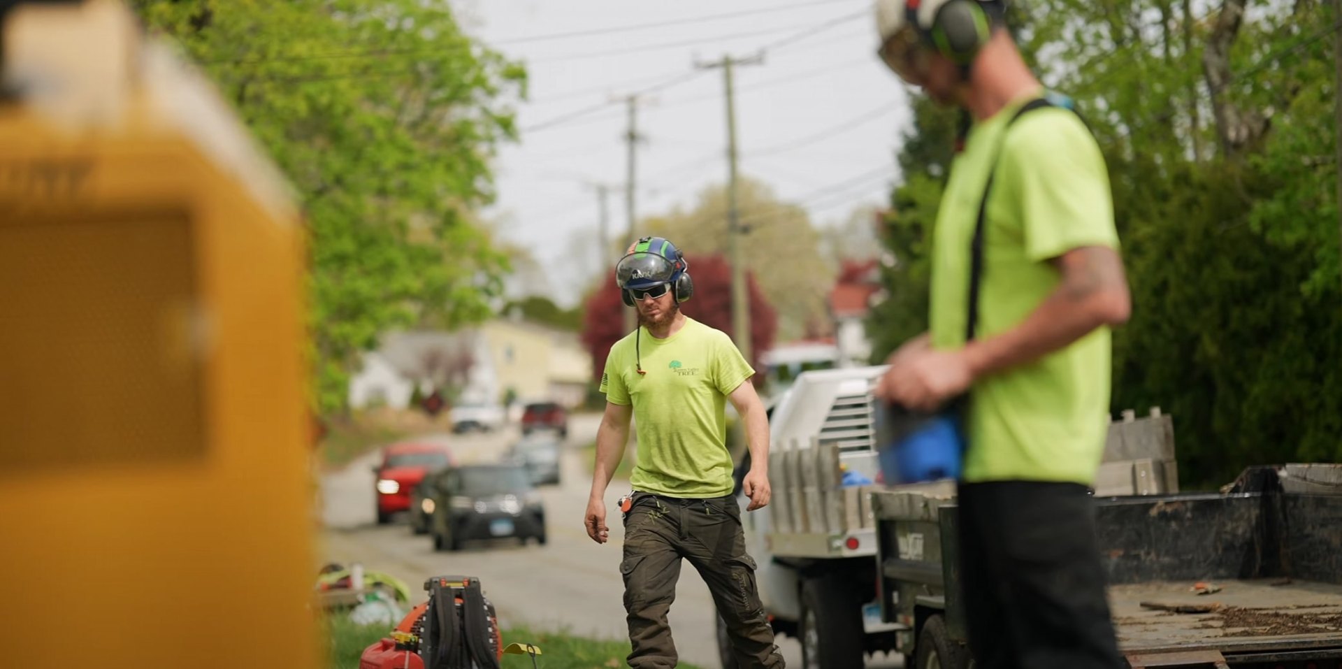 Professional Tree Service Team in Action Tree service crew working with safety equipment on residential street