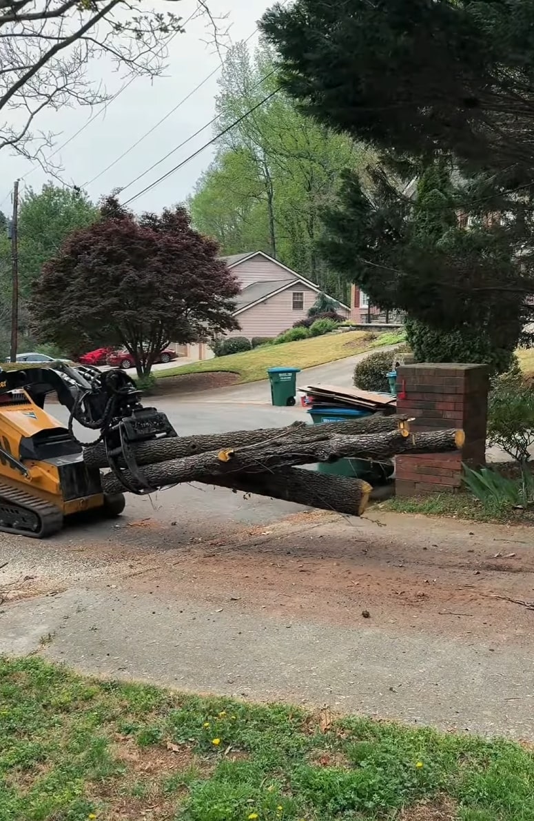 Safe Tree Removal in Residential Areas Tree removal equipment moving large tree logs in residential neighborhood